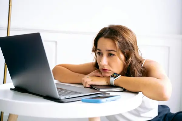 Professional woman experiencing migraine headache at work in Orlando office setting